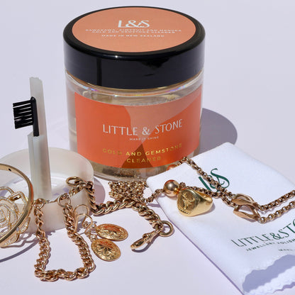Jewelry set with 'Little & Stone' branded items on a white background