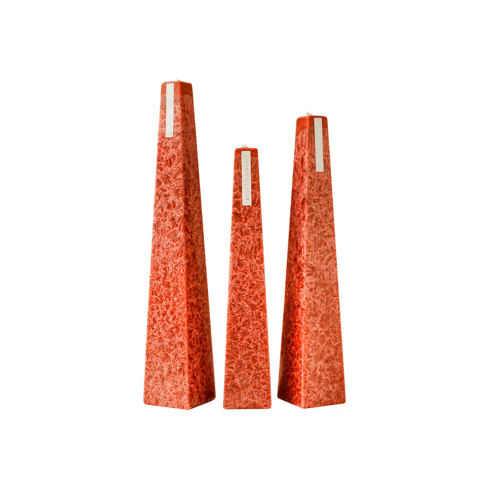Set of three orange textured vases on a white background