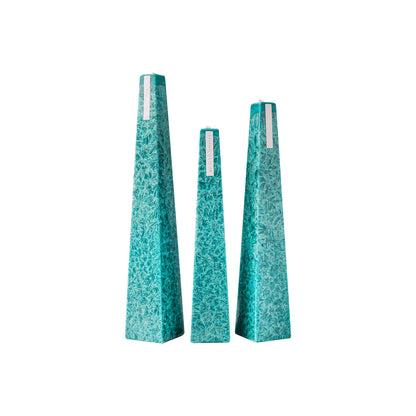 Set of three textured teal vases on a white background