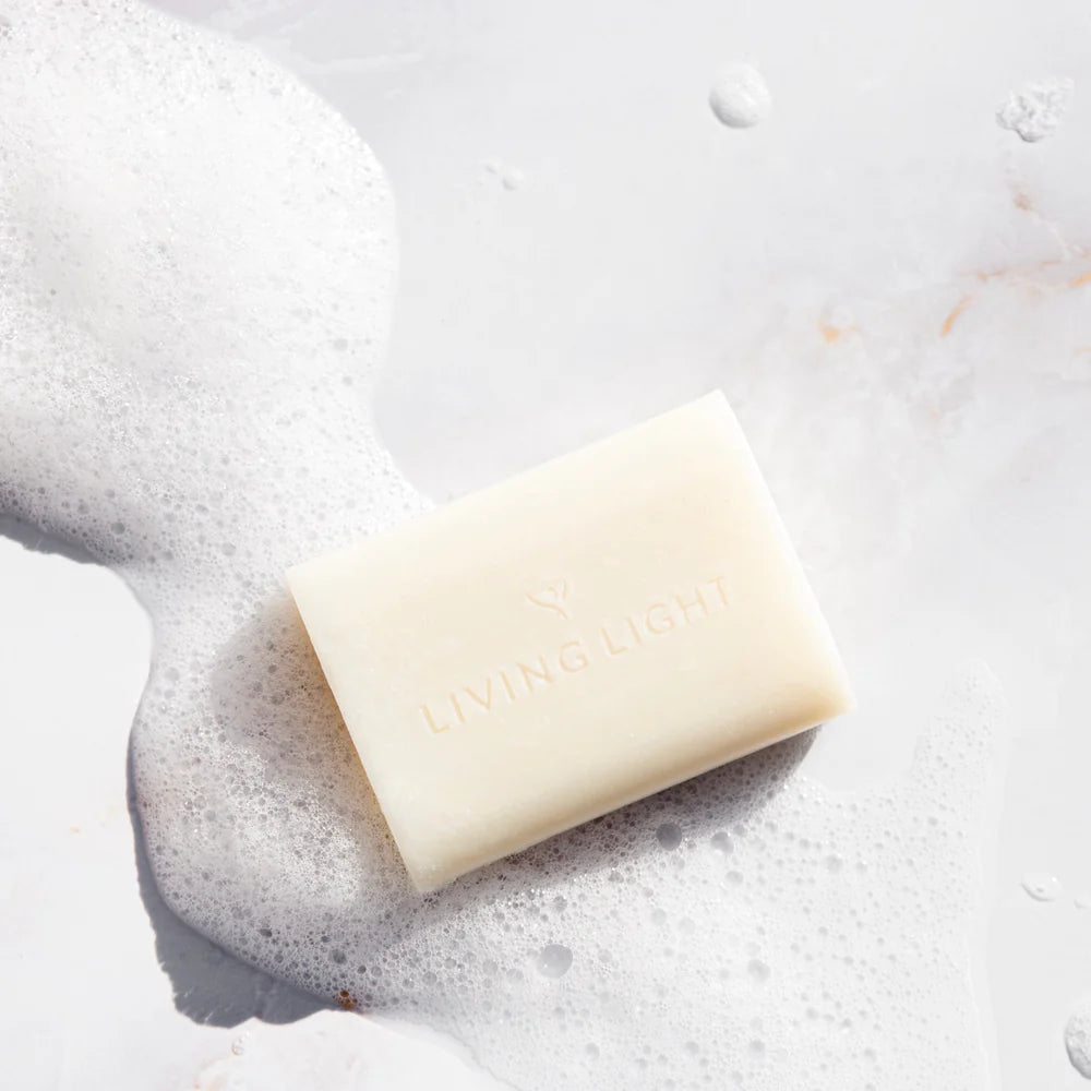 Bar of soap with 'COCO NUT' branding on a white background with soap suds.