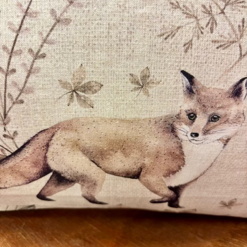 Illustration of a fox on a fabric background with floral patterns