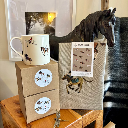 A white bone china mug with equestrian sport designs, displayed alongside its packaging which has similar design elements.