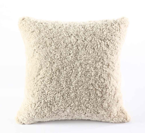 Textured beige short NZ wool pillow on a white background