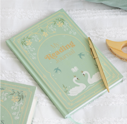 Decorative notebook with swan design and gold text on a white surface