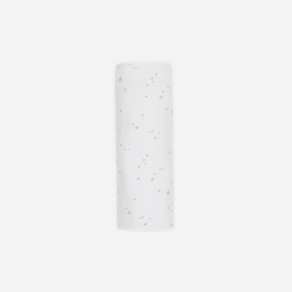 White cylindrical object with small black dots on a white background