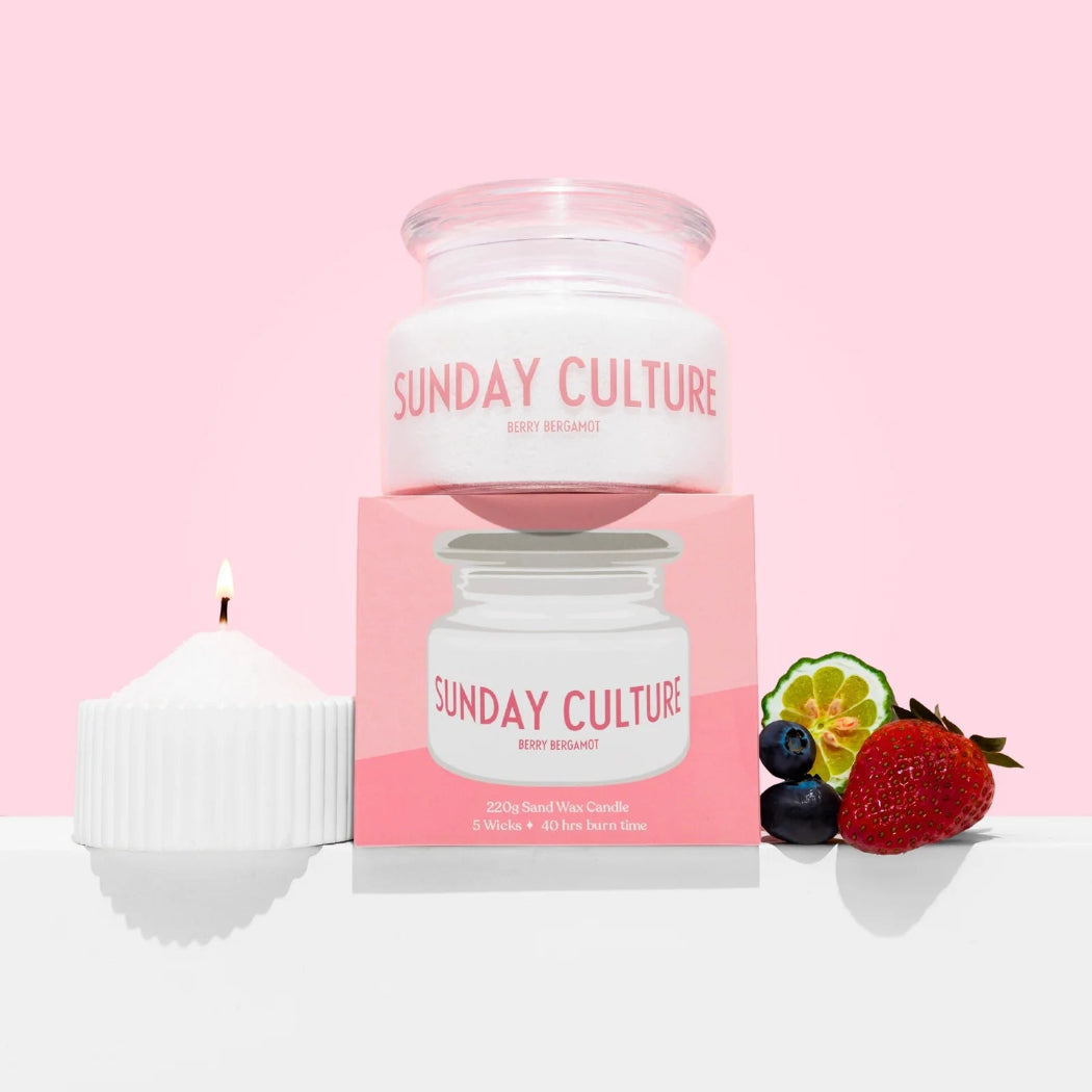 Sunday Culture candle and packaging on a pink background