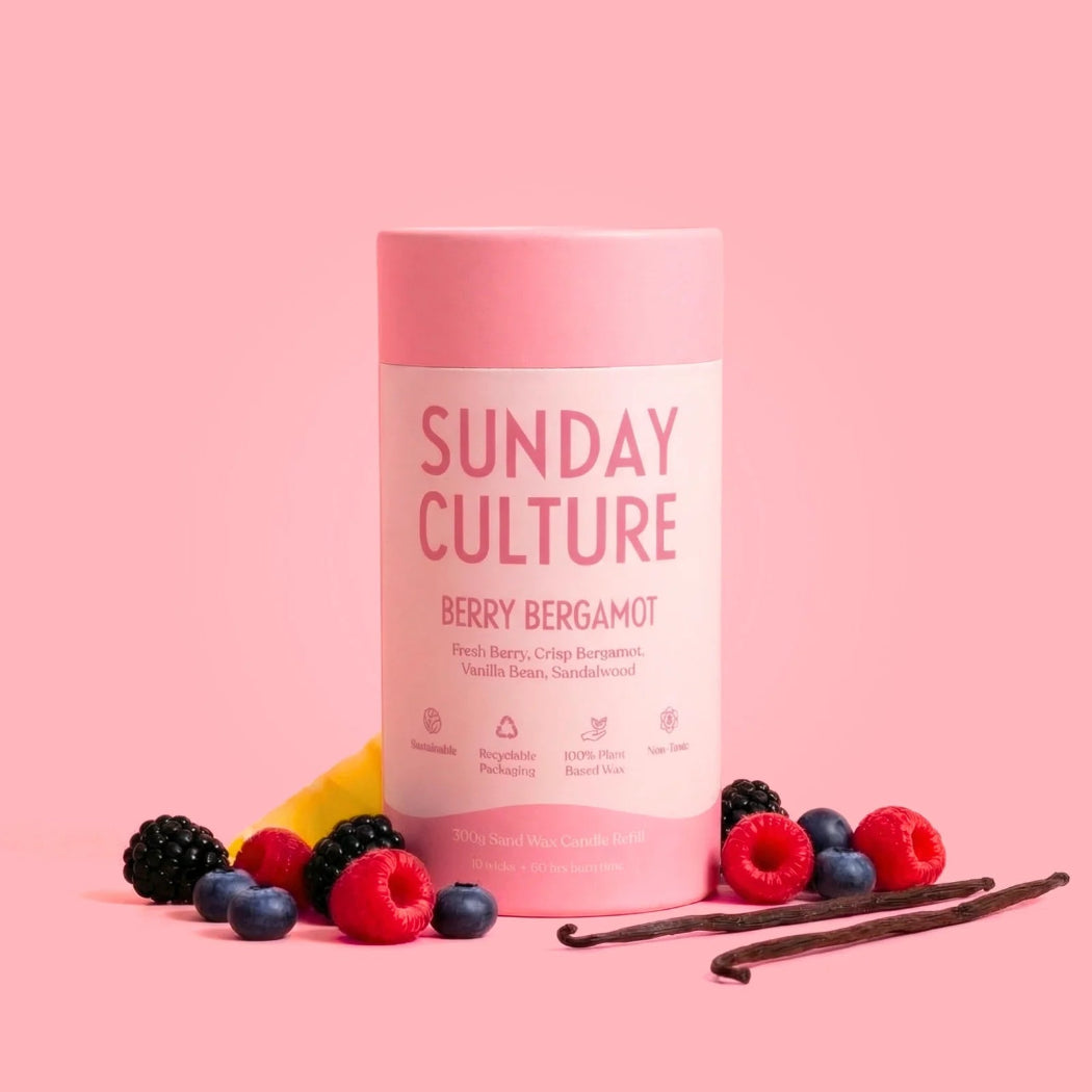 Pink container labeled 'Sunday Culture' with berries and vanilla beans on a pink background