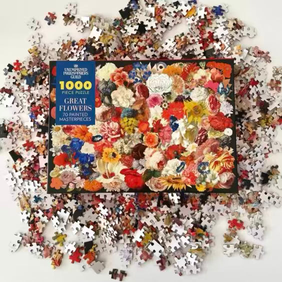 Jigsaw puzzle with a completed floral design and scattered pieces on a white background