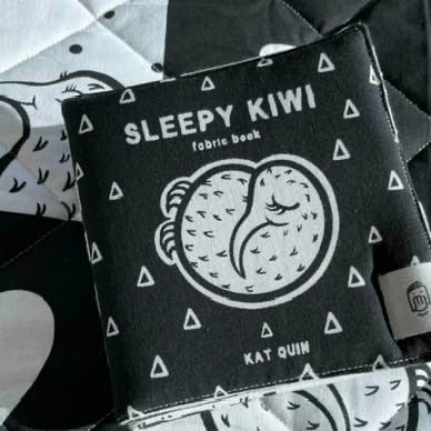 Fabric book titled 'Sleepy Kiwi' by Kat Quin on a patterned background
