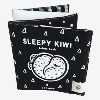 Black fabric book with 'Sleepy Kiwi' text and white triangle patterns on a white background