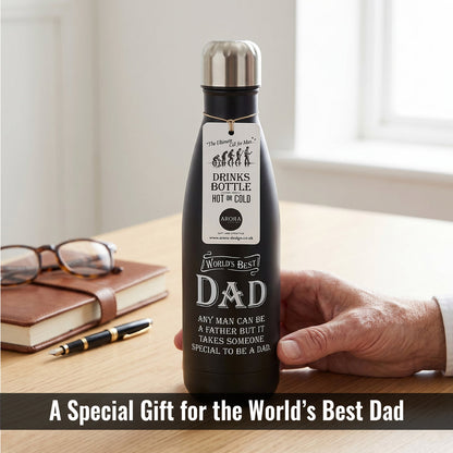 Black insulated drinks bottle with engraved message held by a hand on a wooden surface.