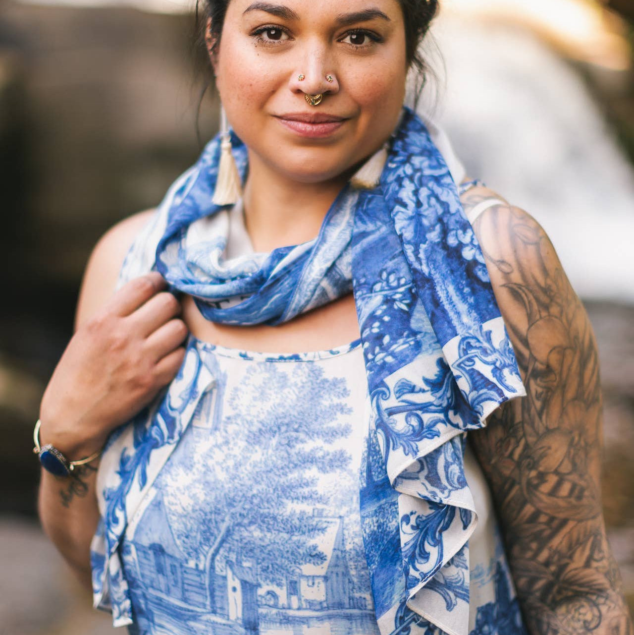 Woman wearing a blue patterned scarf outdoors