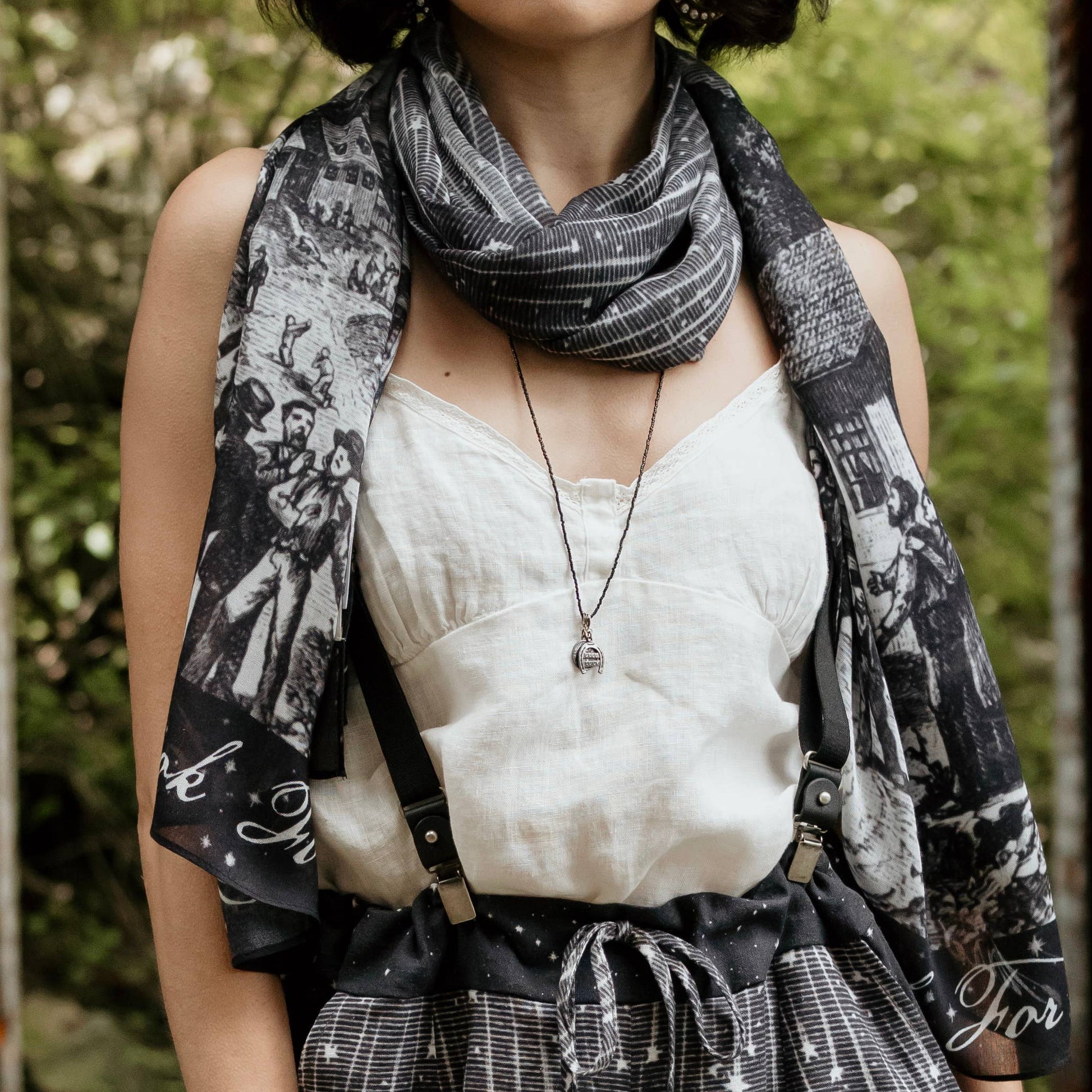 Woman wearing a black and white patterned scarf outdoors