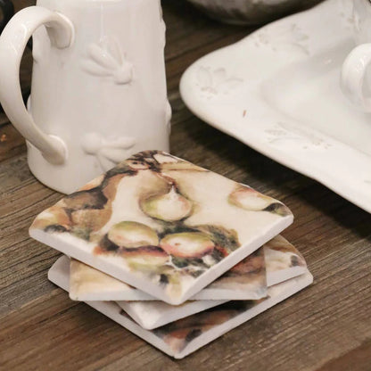 White ceramic mug and coasters with shell design on a wooden surface