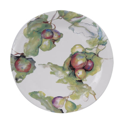 A round white ceramic plate featuring a watercolor-style botanical print of green leaves and clusters of red, purple, and yellow grapes.