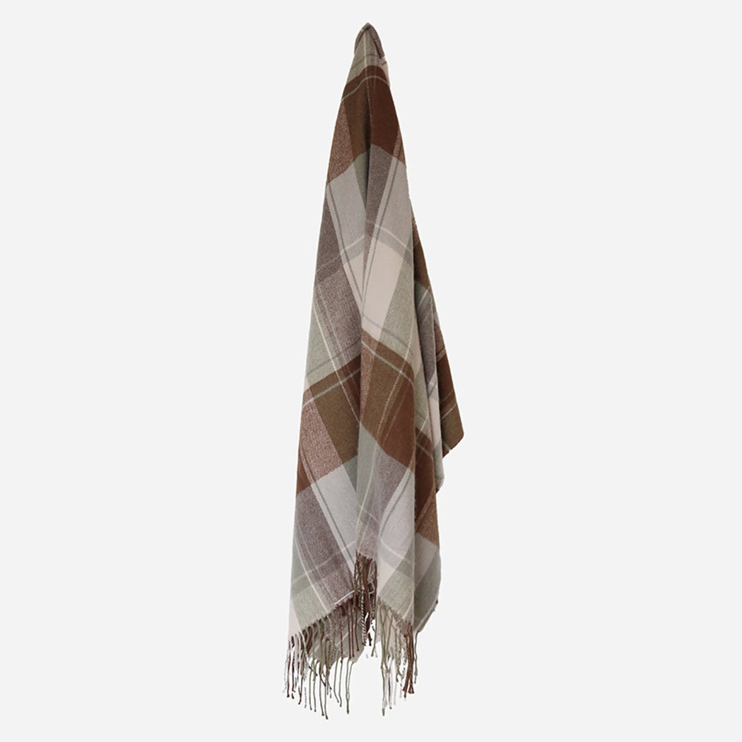 Plaid blanket with fringes on a light gray background