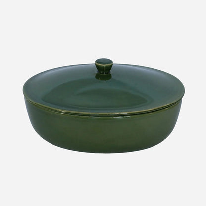 Green ceramic casserole dish with lid on a white background