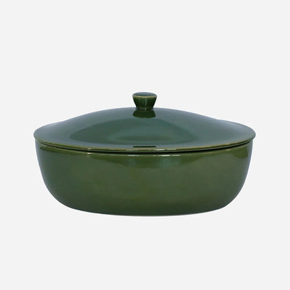 Green ceramic casserole dish with lid on a white background