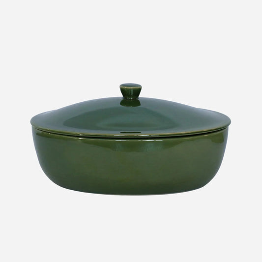Green ceramic casserole dish with lid on a white background
