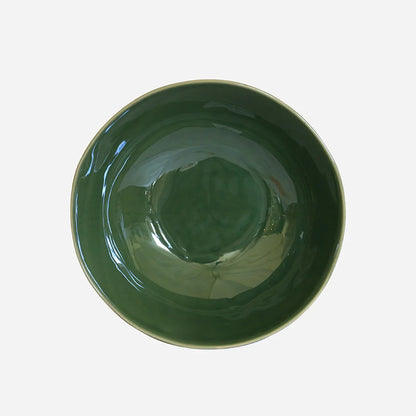 Green ceramic bowl on a white background