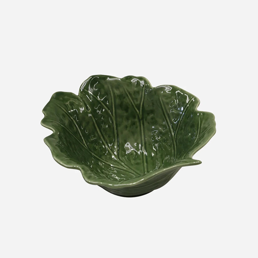 Green leaf-shaped ceramic bowl on a white background
