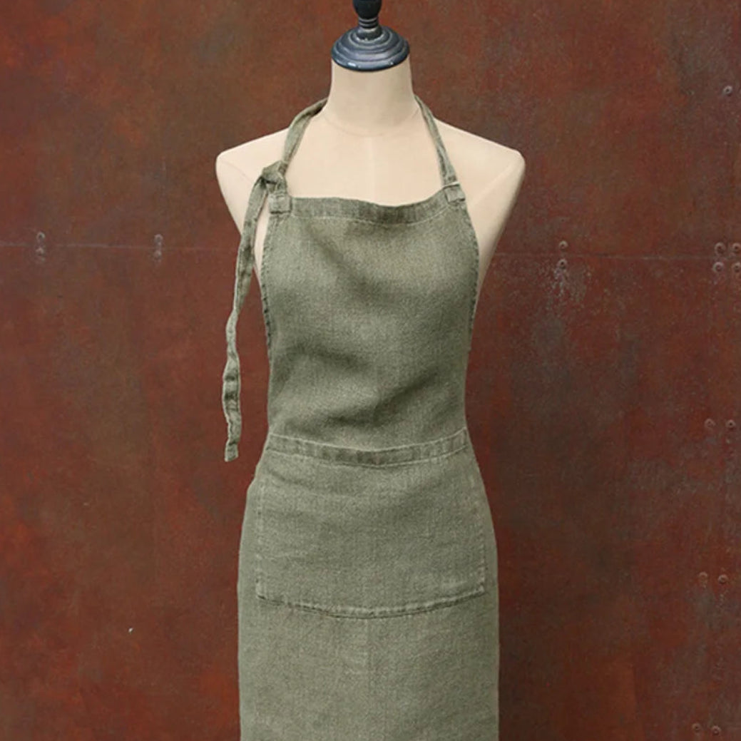 Green apron on a mannequin against a brown background