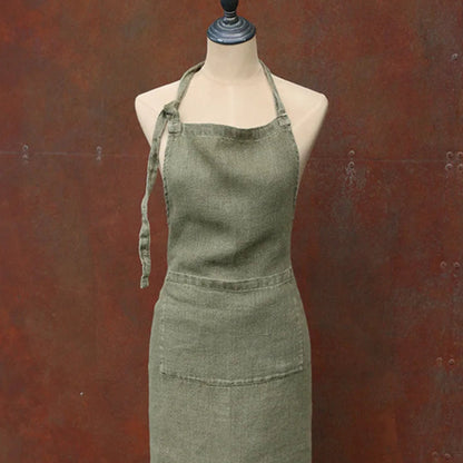 Green apron on a mannequin against a brown background