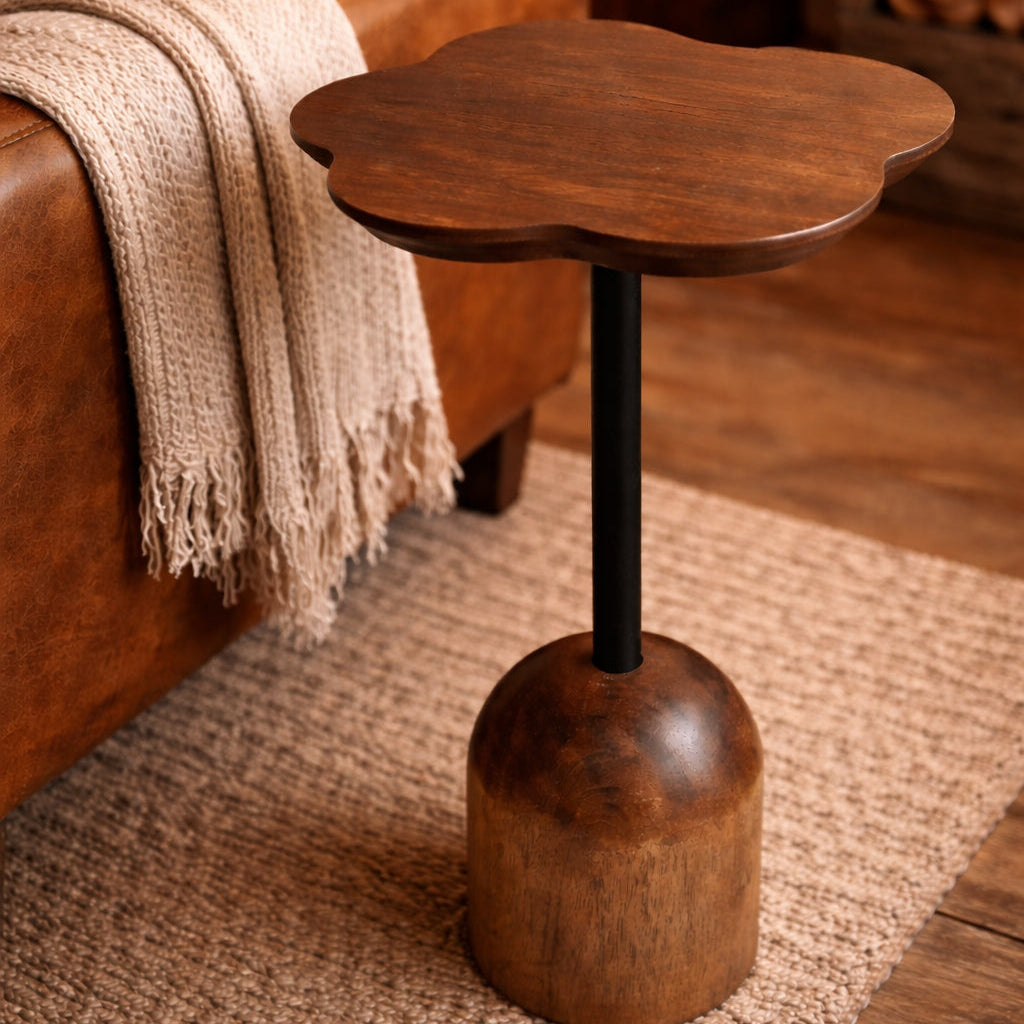Wooden side table in a living room setting with a brown sofa and rug.