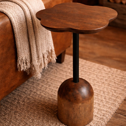 Wooden side table in a living room setting with a brown sofa and rug.