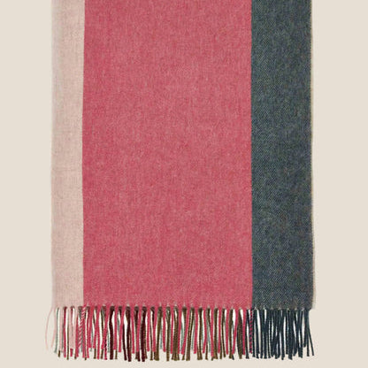 Striped throwwith pink, blue, and beige colors on a beige background