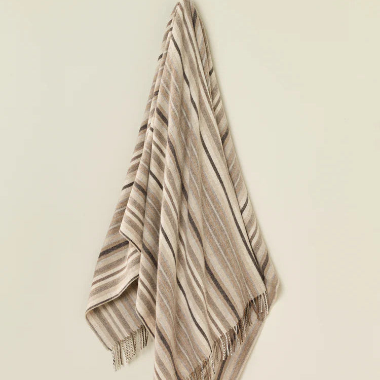 Striped towel hanging on a beige wall