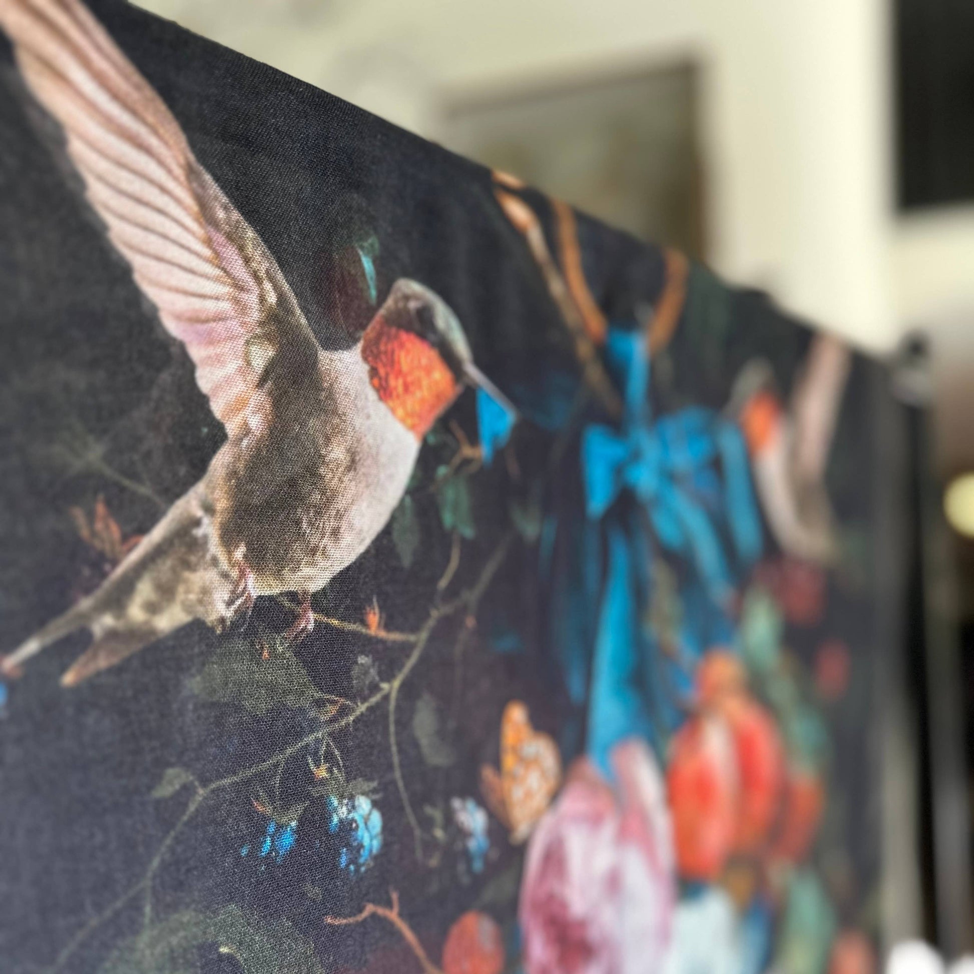 Close-up of a fabric with a bird and floral design, blurred background