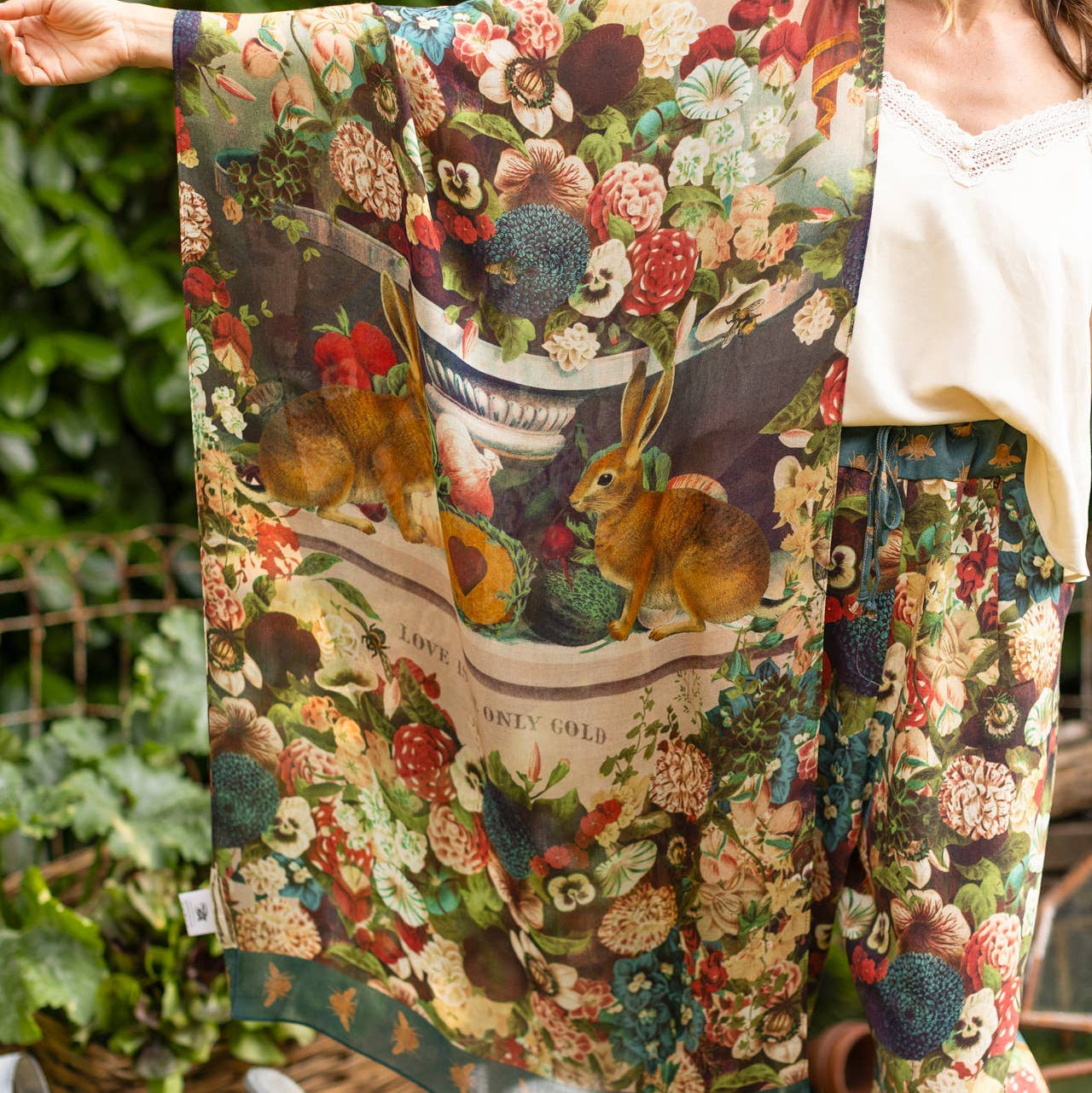 Person wearing a colorful floral and animal print outfit in an outdoor setting.