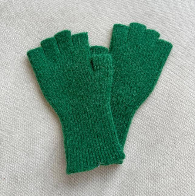 Pair of green fingerless gloves on a light gray background