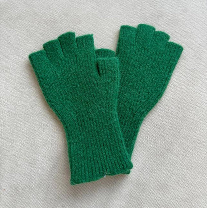 Pair of green fingerless gloves on a light gray background