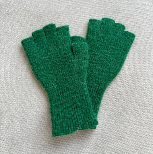 Pair of green fingerless gloves on a light gray background