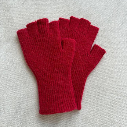 Pair of red fingerless gloves on a light gray background