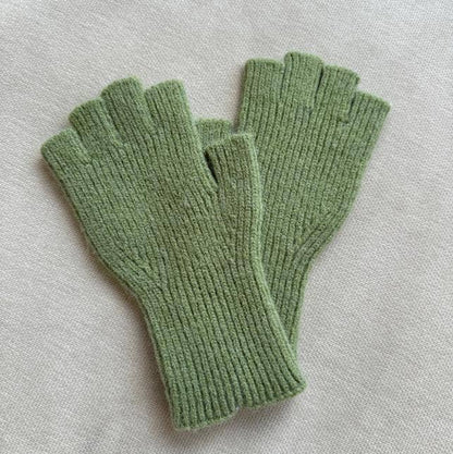 Pair of green fingerless gloves on a light gray background