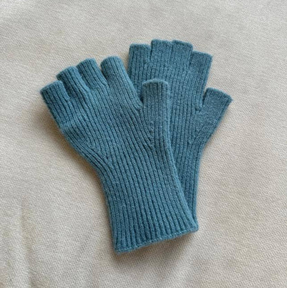 Pair of blue fingerless gloves on a beige surface