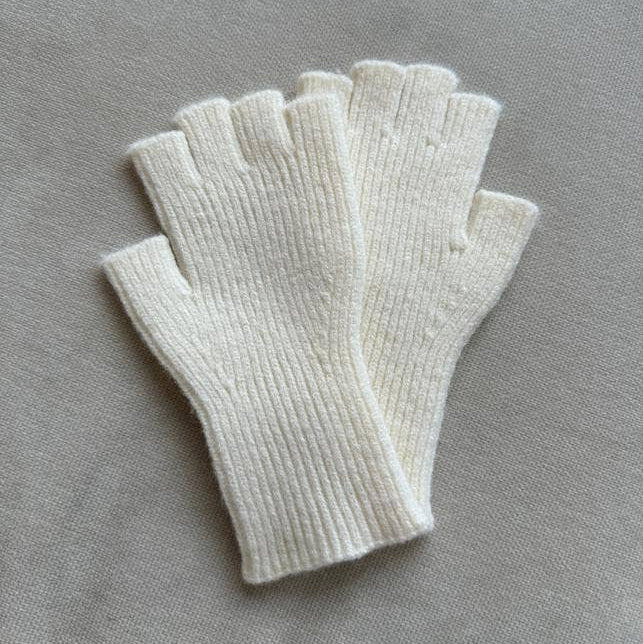 Set of white fingerless gloves on a gray background