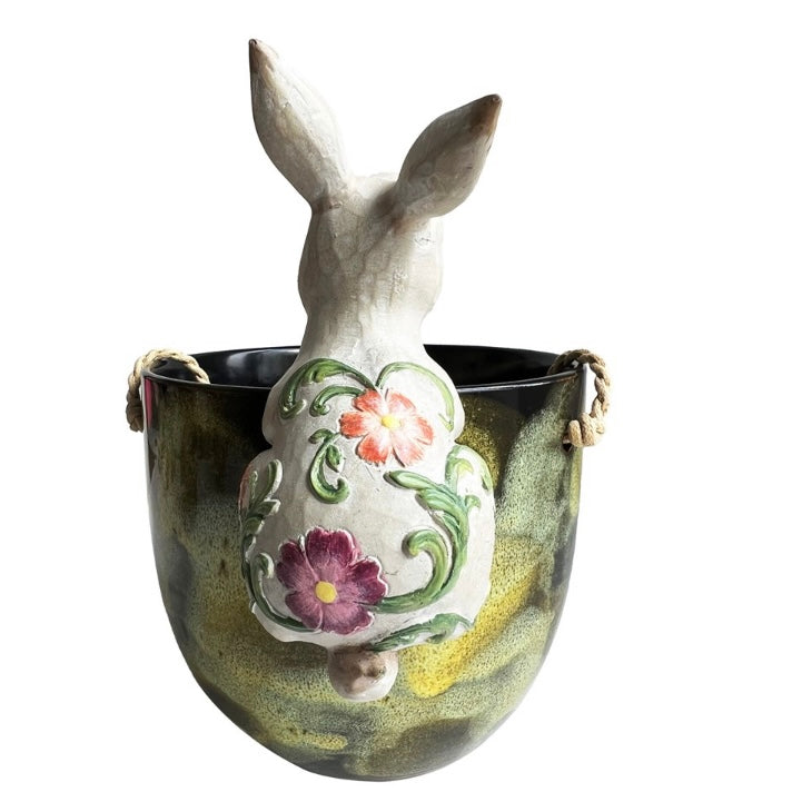 Decorative ceramic vase shaped like a rabbit with floral designs on a white background