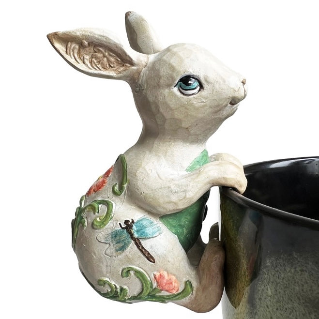 Decorative rabbit-shaped planter with floral designs on a white background