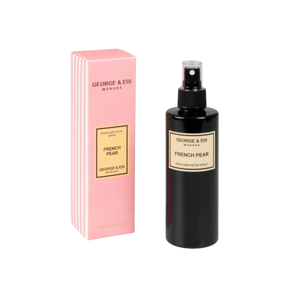 French pear room spray sitting next to it's box and a white background