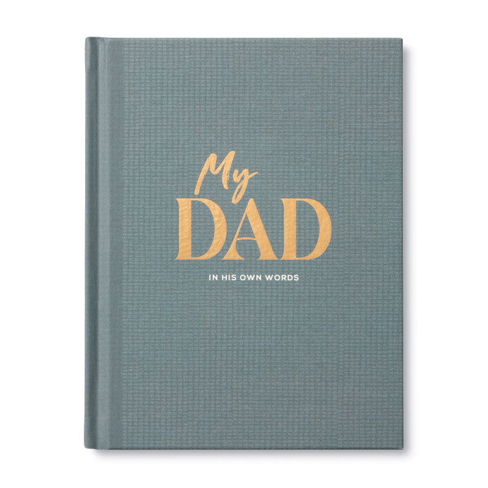 A hardcover journal with a textured slate blue-gray cover, featuring the title 'My DAD' in gold foil lettering and the subtitle 'IN HIS OWN WORDS' in white, shown on a clean white background.