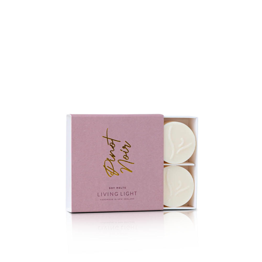 Pink box of 'Living Light' scented candles with 'Pistot Noir' branding on a white background