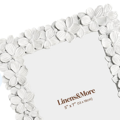 Floral photo frame with 'Linens & More' branding on a white background