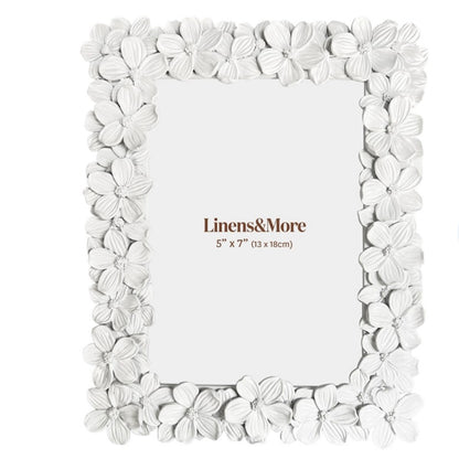 White floral photo frame with 'Linens&More' branding on a white background
