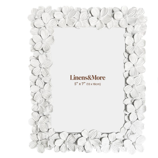 White floral photo frame with 'Linens&More' branding on a white background