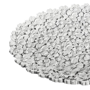 White floral-patterned placemat on a white background