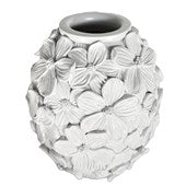 White resin vase with floral patterns on a white background